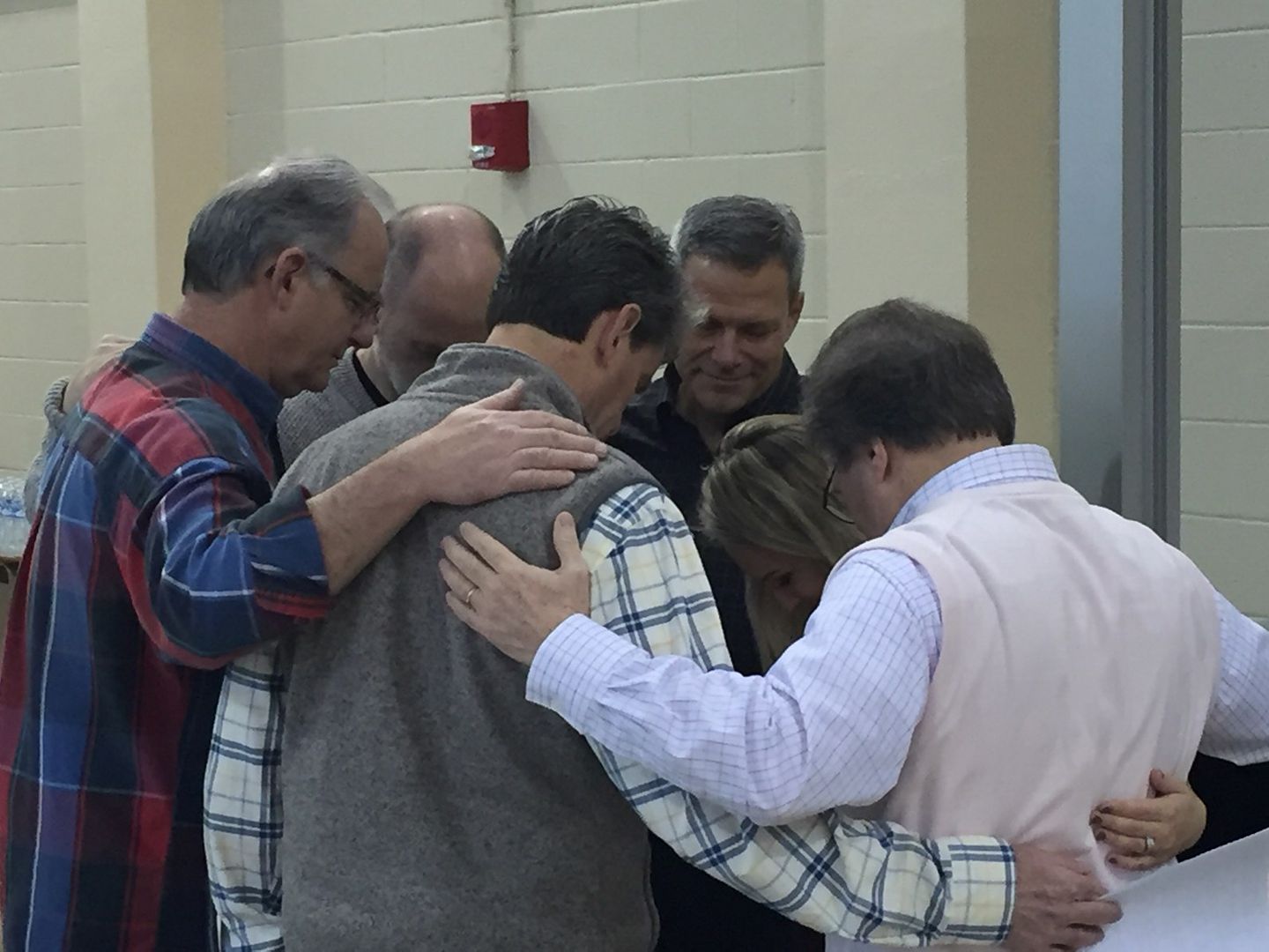 Dr. Carlus Gupton, praying with elders and ministers before beginning of workshop